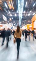 Blurred motion of people at a busy trade show, capturing the energy and movement photo