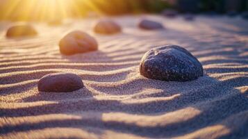 Zen garden texture with rocks and rippled sand, reflecting golden sunlight on peaceful beach photo