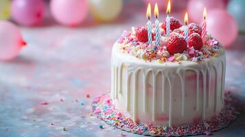 Strawberry birthday cake positioned on frame's right features white dripping glaze, lit candles, and colorful sprinkles, set against soft pastel balloon background. festive photo