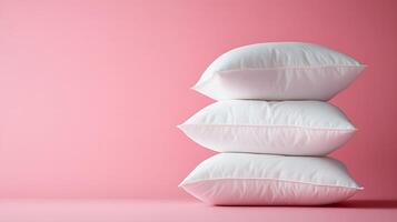 Pure white fluffy pillows stacked against soft pink background create minimalist composition with right-side positioning, emphasizing textile textures and comfort. fluffy photo