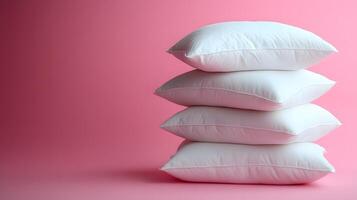 Pure white fluffy pillows stacked against soft pink background create minimalist composition with right-side positioning, emphasizing textile textures and comfort. white photo