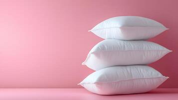 Pure white fluffy pillows stacked against soft pink background create minimalist composition with right-side positioning, emphasizing textile textures and comfort. pink photo