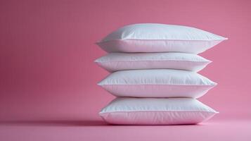 Pure white fluffy pillows stacked against soft pink background create minimalist composition with right-side positioning, emphasizing textile textures and comfort. comfort photo