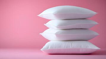Pure white fluffy pillows stacked against soft pink background create minimalist composition with right-side positioning, emphasizing textile textures and comfort. essentials photo