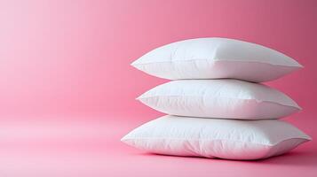 Pure white fluffy pillows stacked against soft pink background create minimalist composition with right-side positioning, emphasizing textile textures and comfort. bedroom photo
