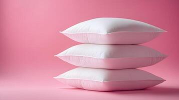 Pure white fluffy pillows stacked against soft pink background create minimalist composition with right-side positioning, emphasizing textile textures and comfort. cozy photo
