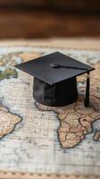 Graduation cap placed on an old world map highlighting Africa's diverse geography. photo