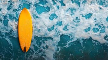 Bright yellow surfboard resting on vibrant turquoise ocean waves during sunny day. photo