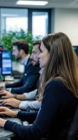 Professionals engaged in teamwork at modern office with computers in a bright workspace. photo