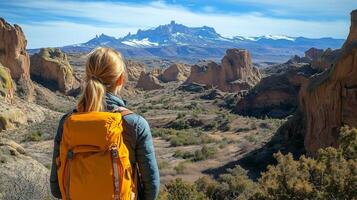 Stunning mountain landscape viewed by hiker with yellow backpack during clear day in national park. photo