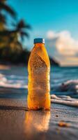 Refreshing drink bottle on a sunny beach at sunset with ocean waves. photo