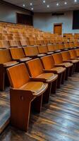 Wooden seating arrangement in an empty auditorium during early evening hours. photo