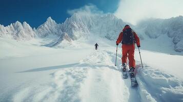 Snowy mountain adventure with skiers traversing a winter landscape under a clear blue sky. photo