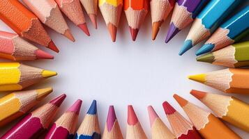 Colorful array of pencils arranged in a circular pattern on a white background. photo