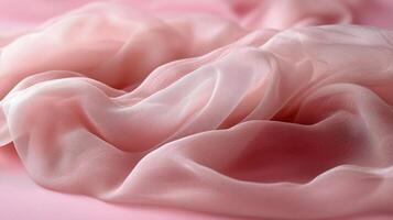 Soft pink fabric draped elegantly on a smooth surface for textile display and design inspiration. photo