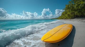 Surfboard on sandy beach with turquoise water under a bright sky in a tropical paradise. photo