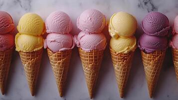 Colorful ice cream cones arranged neatly on a marble surface at a dessert shop. photo