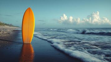 Surfboard resting on wet sand as waves crash during early morning light by the shore. photo