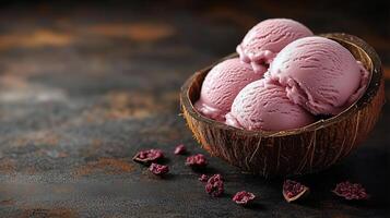 Creamy pink ice cream scoops served in a coconut shell on a rustic wooden table. photo