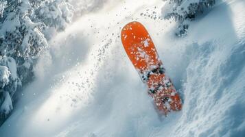 Snowboarder performing a thrilling trick in fresh powder at a mountain resort during winter. photo