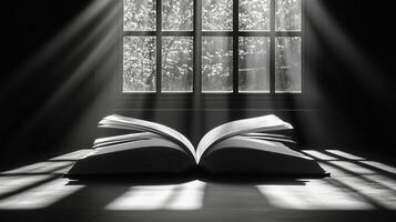 Light streaming through a window illuminates an open book on a table in a quiet room. photo