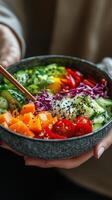 Colorful bowl of fresh vegetables and salmon at a cozy indoor setting. photo