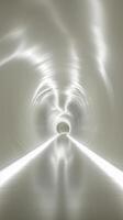 Light reflections create a striking visual journey through a modern tunnel interior. photo