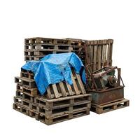 A pile of pallets with blue tarp on top photo