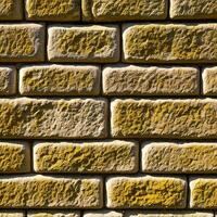 A close up of a wall made of yellow bricks photo