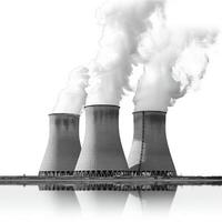 Three cooling towers with smoke coming out of them photo