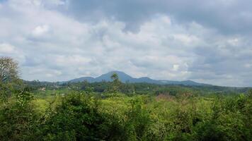 Mountain view, lush foliage, cloudy sky, rural landscape, tourism photo