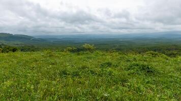 Hilltop Grassland Vista Cloudy Sky, Distant Mountains photo