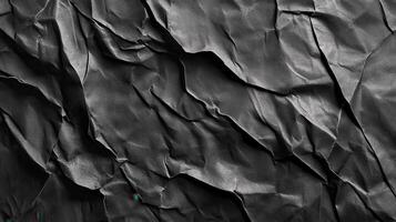 Crumpled dark paper texture, abstract background, design element photo