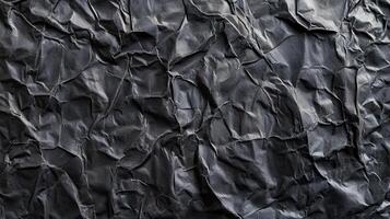 A black crumpled paper texture background photo