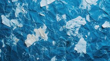 Crumpled blue paper texture with white scraps, background design photo