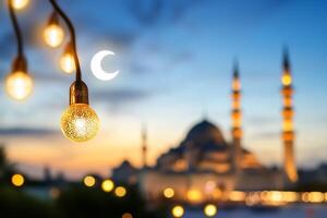Illuminated mosque at twilight with crescent moon photo