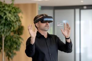 Businessman using VR headset, office background, data visualization photo