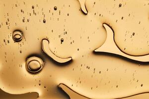 The beautiful texture of the cosmetic serum on a gold background that takes up most of the photo. photo