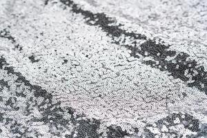 Abstract festive fabric texture with silver sequins. photo