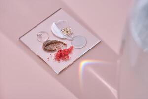 Different textures of skin care products on a square stand with beautiful caustics. photo