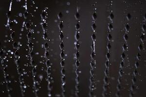 Abstract texture of water jets from the shower in close-up. photo