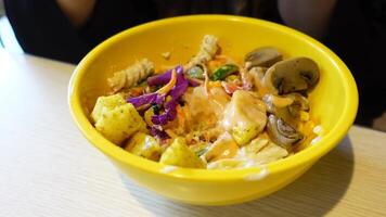 Healthy bowl filled with vegetables and sauce in local cafe setting video