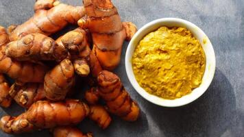Turmeric roots and fresh turmeric paste preparation in kitchen video