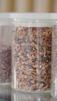 Crunchy granola and nut mix stored in clear containers video
