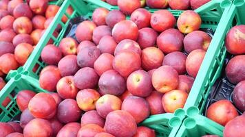 Fresh apples stacked in green crates at local market video