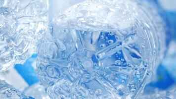 Ice cubes sparkle in clear water with bubbles visible video