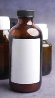 Glass amber bottles stand on a gray surface for storage or display video