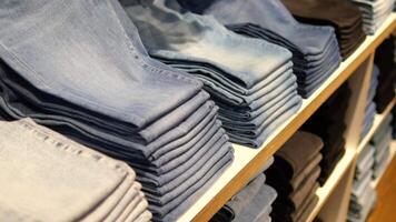 Stacks of folded jeans arranged neatly in a retail store video