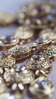 Sparkling gold jewelry shines under soft light in close-up view video