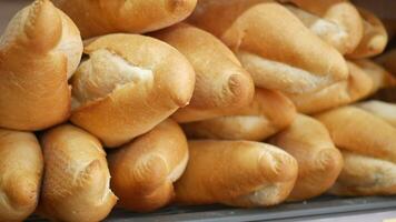 Freshly baked bread rolls stacked in a local bakery display video